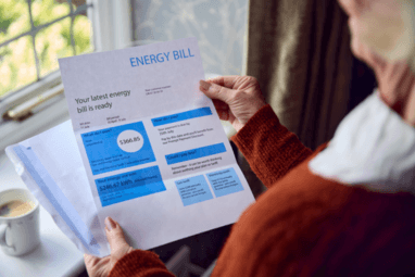 Image of a woman reading power bill