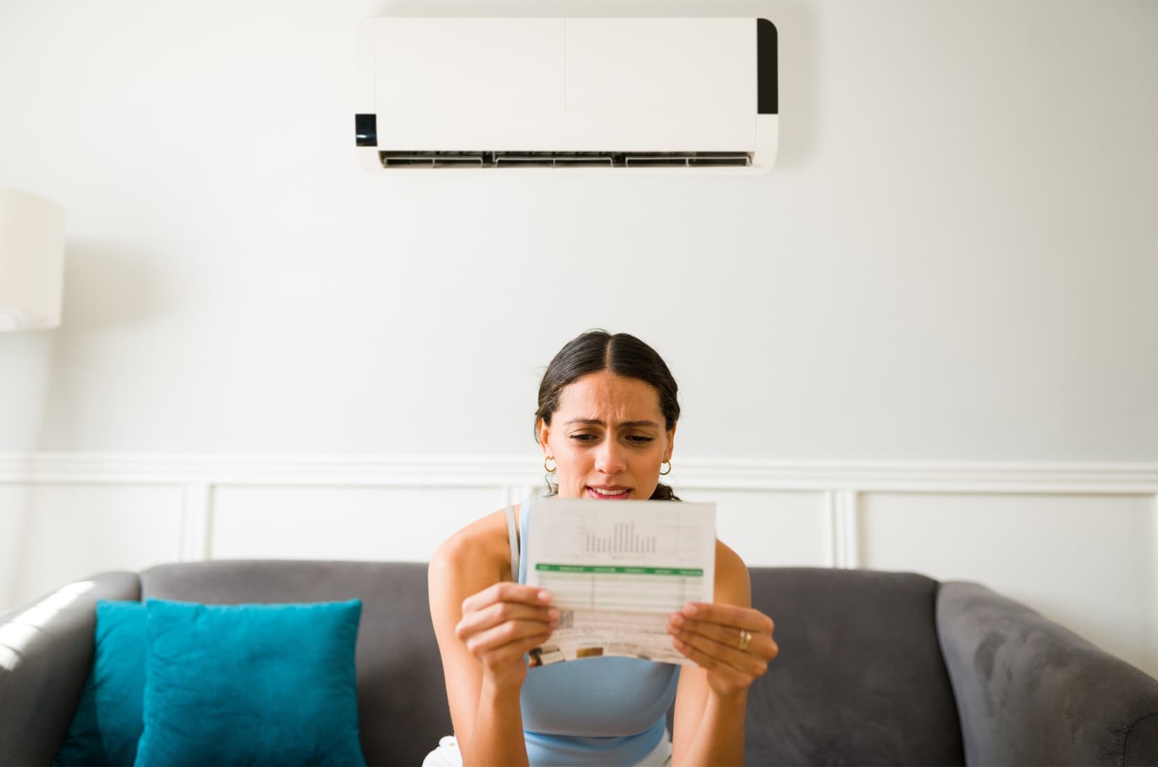 Woman looking at high power bill.